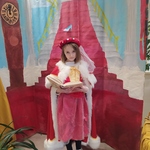 Dziewczynka przebrana w suknię księzniczki czyta książkę..jpg