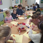 Dzieci wykonują pracę plastyczną lepiąc kolorowe kulki.jpg