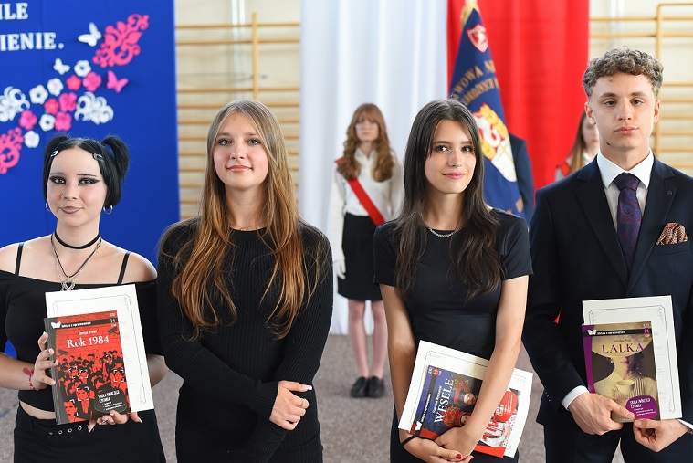 Trzy dziewczyny i chłopak elegancko ubarni pozują do zdjęcia..jpg