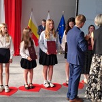 Trzy dziewczyny pozują do zdjęcia na czerwonych sercach ułożonych na podłodze.jpg