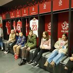 Uczniowie siedzą w szatni piłkarzy.