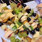 Zdjęcie szaszłyków z owocami ułożonych na talerzu.