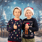 Dwóch chłopców ubranych w bożonarodzeniowe stroje pozuje do zdjęcia świątecznego