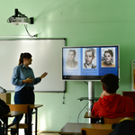 Uczniowie obserwują pokaz prowadzony przez panią z IPN.